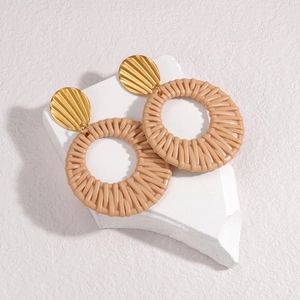 Bohemian gold shell studs with khaki woven hoop pendants on a minimalist stone base