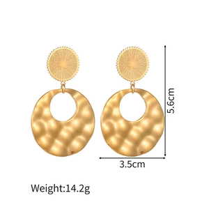 Detailed view of matte gold star earrings with dimensions 5.6cm by 3.5cm and 14.2g weight