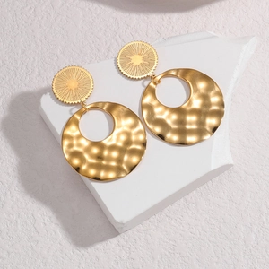Vintage irregular hollow gold-plated drop earrings with hammered texture on stone display