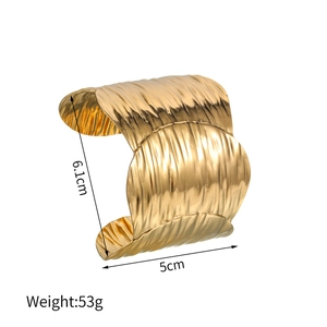 Detailed view of wide irregular wave texture gold bangle with 5cm width measurement