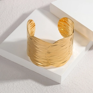 Minimalist 18K gold textured wide cuff bracelet with irregular hammered metal finish