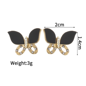 Detail of butterfly stud earrings with black enamel and white crystal pave on gold base