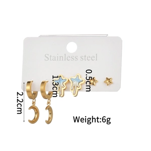 Detailed view of 3-pair stainless steel earring set with gold moon and star designs