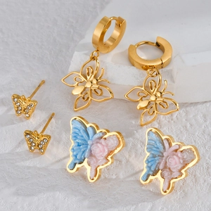 Exquisite butterfly earring set with gold hoops, rhinestone studs, and floral enamel details