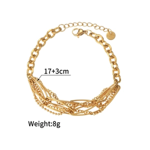 Detail of layered stainless steel gold bracelet with lobster clasp and extension chain