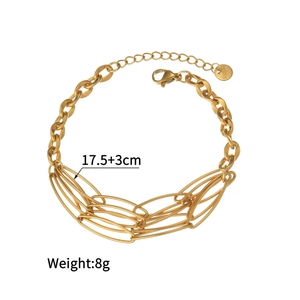 Detail of gold oval link chain bracelet with lobster clasp and S.steel tag on white background