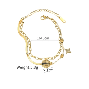 Detail of gold layered bracelet with ladybug and star charms on white background
