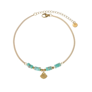 Detail of a gold stainless steel anklet featuring turquoise beads and a seashell pendant