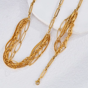Layered gold titanium steel necklace featuring paperclip and twist chains on stone