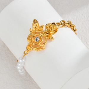 Golden rose pearl bracelet with vintage hollow flower and crystal inlay on a display stand