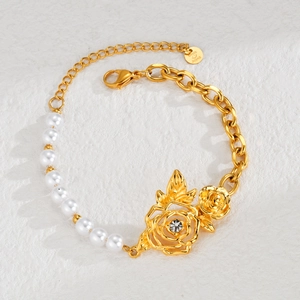 Elegant gold chain and pearl bracelet featuring a hollow rose charm with sparkling crystal