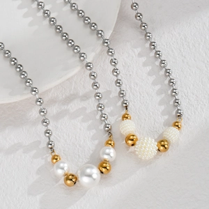 Minimalist pearl and gold bead necklace with silver ball chain shown on white stand