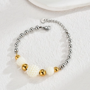 Detail of beaded bracelet featuring silver and gold beads with S.Steel lobster clasp