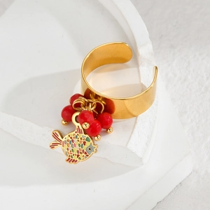 Detail of 18k gold stainless steel open ring with colorful fish pendant and red beads