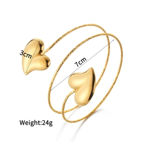Gold spiral open bracelet featuring double heart charms and textured anti-slip finish