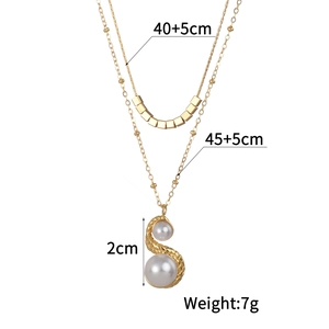 Double-layer gold necklace with square charms and faux pearl pendant on white background