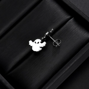 Macro shot of polished stainless steel ghost stud earrings for Halloween style
