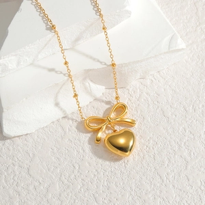 Elegant gold titanium steel heart and bow necklace with beaded chain for women