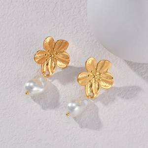 Detail of golden flower stud earrings with elegant baroque pearls on white background