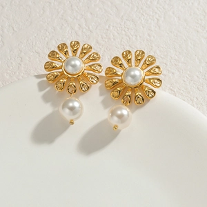 18k gold-plated sunflower earrings with teardrop pearls on a minimalist background