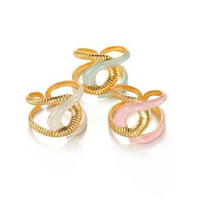 Detail of twisted spiral open rings with light blue cream and pink enamel coatings