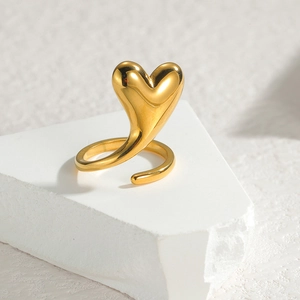 Minimalist gold heart-shaped open ring with polished 3D design on a white stone base
