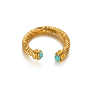 Gold twisted cable cuff bracelet featuring round turquoise insets with a 45-degree angle view