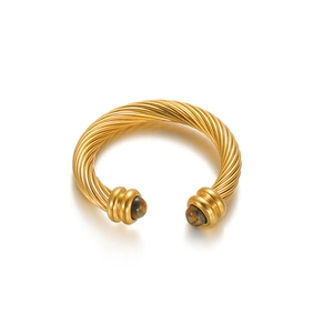 Detail of 18k gold twisted cable cuff bracelet featuring tiger eye stone inlays