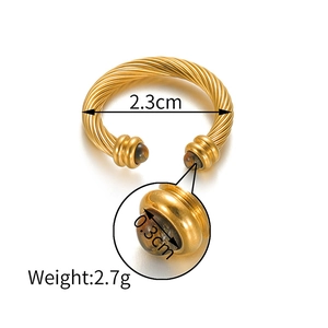 Detailed view of golden twisted bangle with 0.3cm brown tiger eye stone spheres