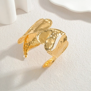 Modern wide hammered gold heart cuff bracelet in a minimalist artistic open design