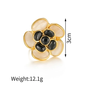 Macro detail of 3cm camellia earring with opal petals and black gems, weight 12.1g