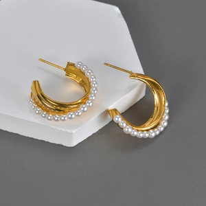 Elegant C-shaped gold hoop earrings with white pearls and stainless steel minimalist design