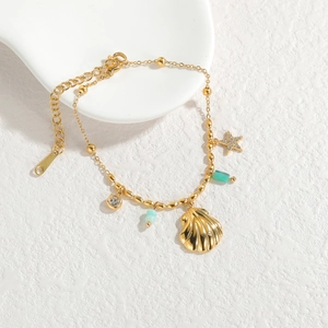 Elegant 18k gold ocean starfish and shell bracelet with green gemstone accents