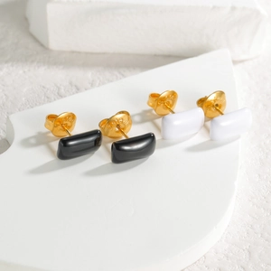 Detail of minimalist rectangular earrings in black and white with steel backings
