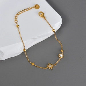 Elegant gold stainless steel bracelet featuring star pendant and zircon on stone