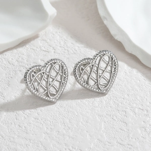 Elegant hollow heart stud earrings in silver finish with intricate lace texture design