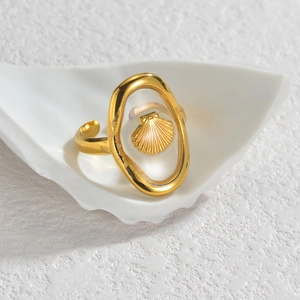 Adjustable gold starfish ring in a shell tray with minimalist ocean-themed design