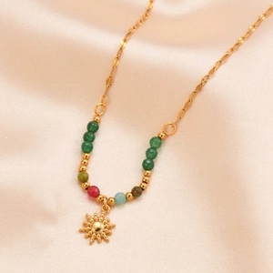 Bohemian gold sun pendant necklace with vibrant colorful beads on beige silk