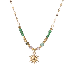 Bohemian style gold beaded necklace with colorful stones and a radiant sun pendant