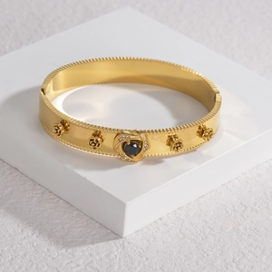 Gold flower bangle with black center stone and micro-pave crystals in retro style