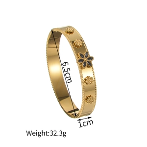 Elegant gold plated stainless steel floral bangle with black stone and 6.5cm diameter