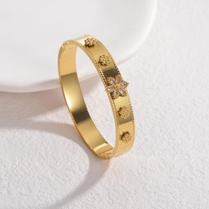Elegant gold-plated stainless steel cuff bracelet with floral relief and crystal inlay