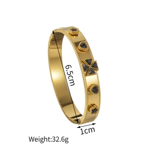 Vintage gold plated stainless steel bangle with black stone inlay and beaded texture