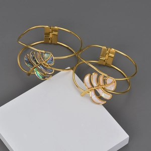 Close-up of open bangle set with leaf-shaped abalone and mother of pearl inlays