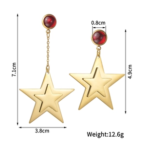 Asymmetric gold stainless steel star earrings with red bead accents and dimension details