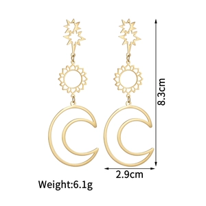 Detail view of 18K gold earrings with star sun and moon charms showing 8.3cm length