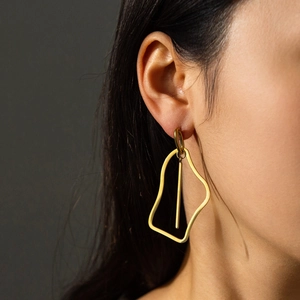 Modern irregular geometric hollow drop earrings in polished 18K gold titanium steel