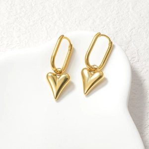Polished 18K gold plated stainless steel puffy heart drop earrings on white ceramic base