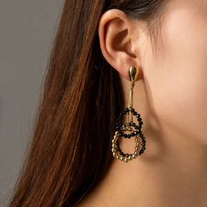 Elegant gold teardrop earrings with black and gold beaded tassel rings for women