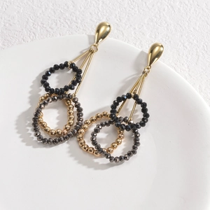 Elegant gold drop earrings with triple layers of black, gold, and grey faceted beads